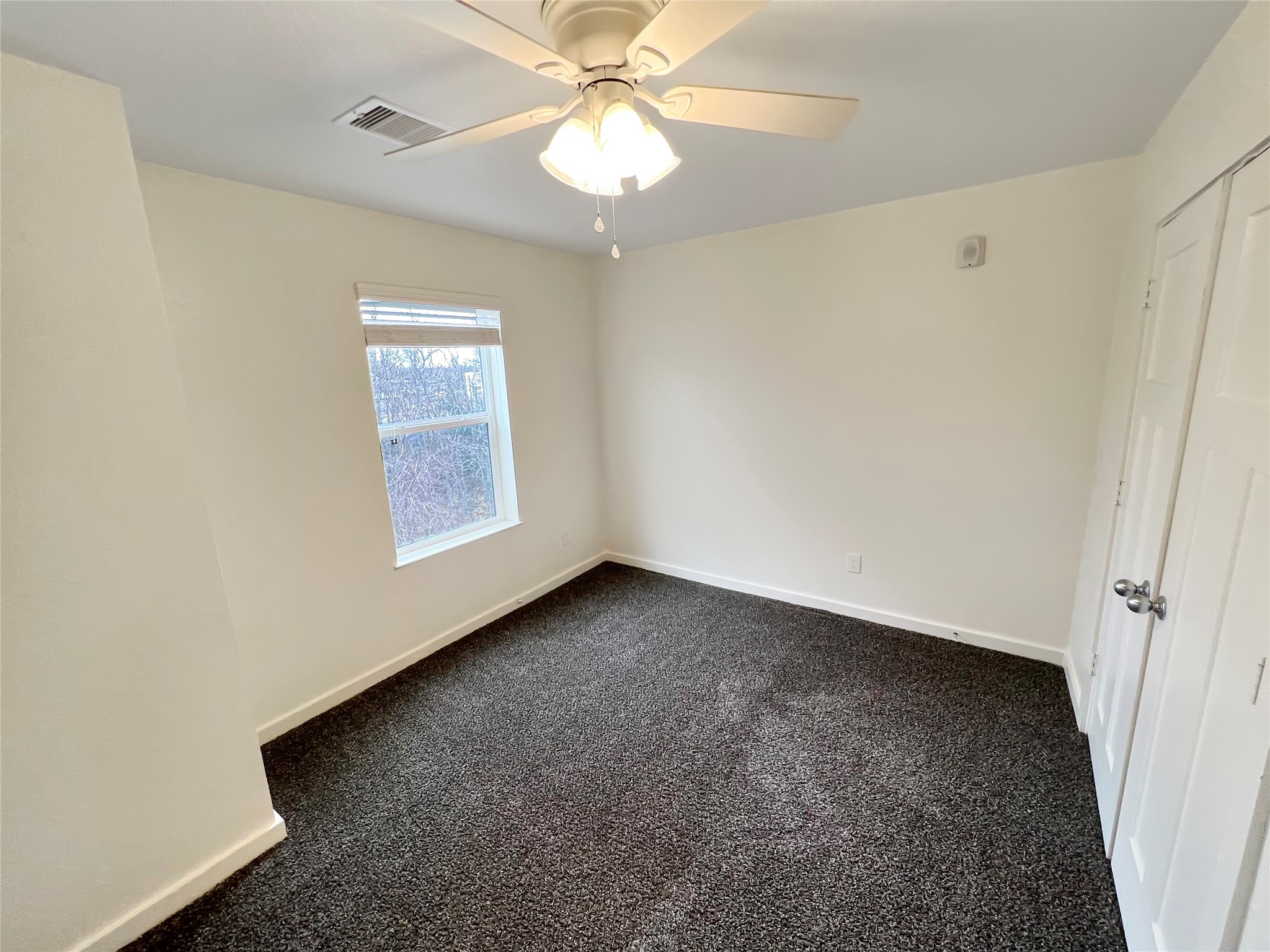 21155 Gosling Road, Unit 48 AD Spring, TX 77388 - Photo 20 of 20 an empty room with a chandelier fan and windows