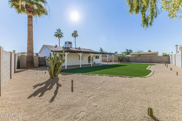 a swimming pool with a yard and seating space