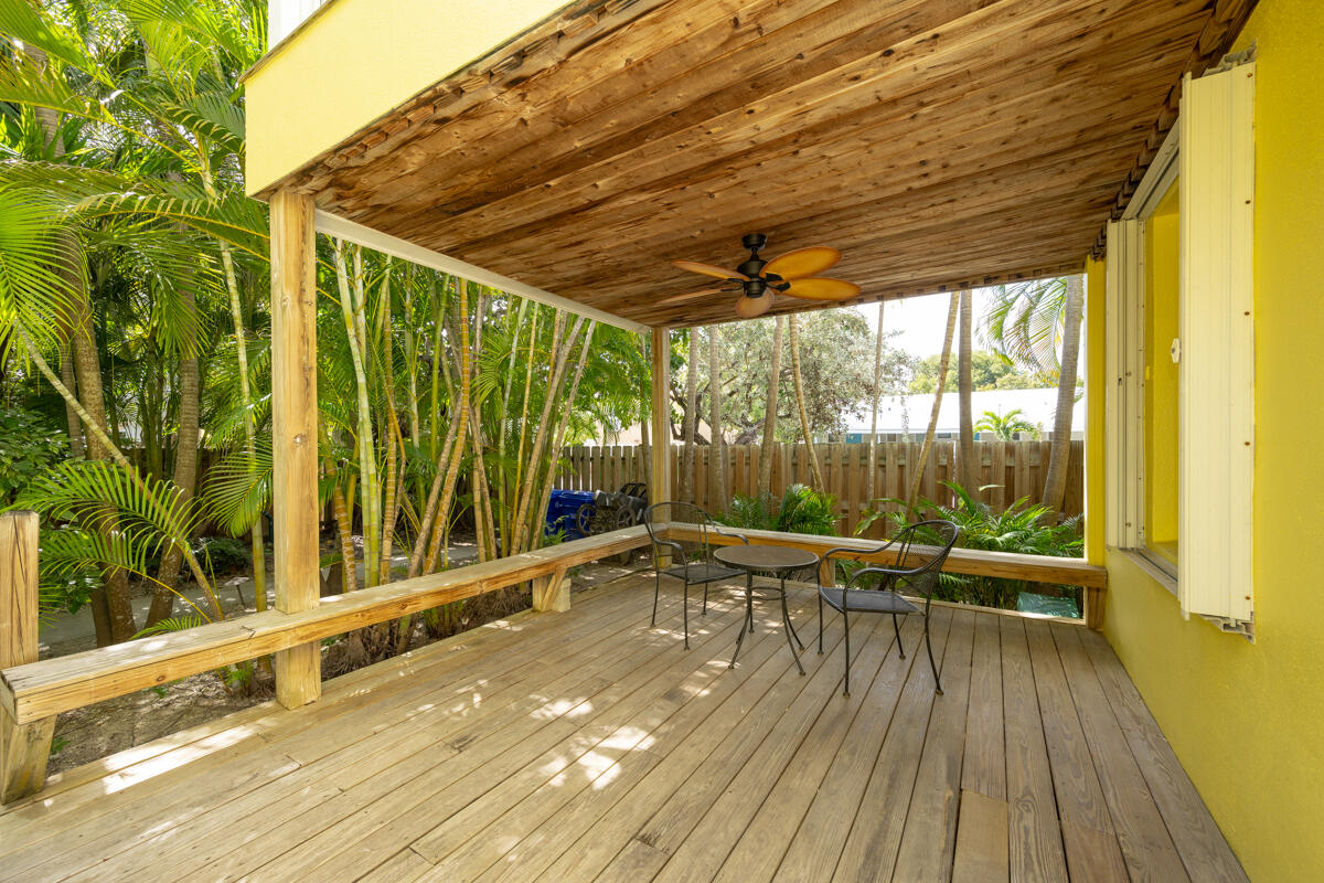 804 South Street, Unit 2 Key West, FL 33040 - Photo 11 of 17 a view of a patio with table and chairs wooden floor and fence