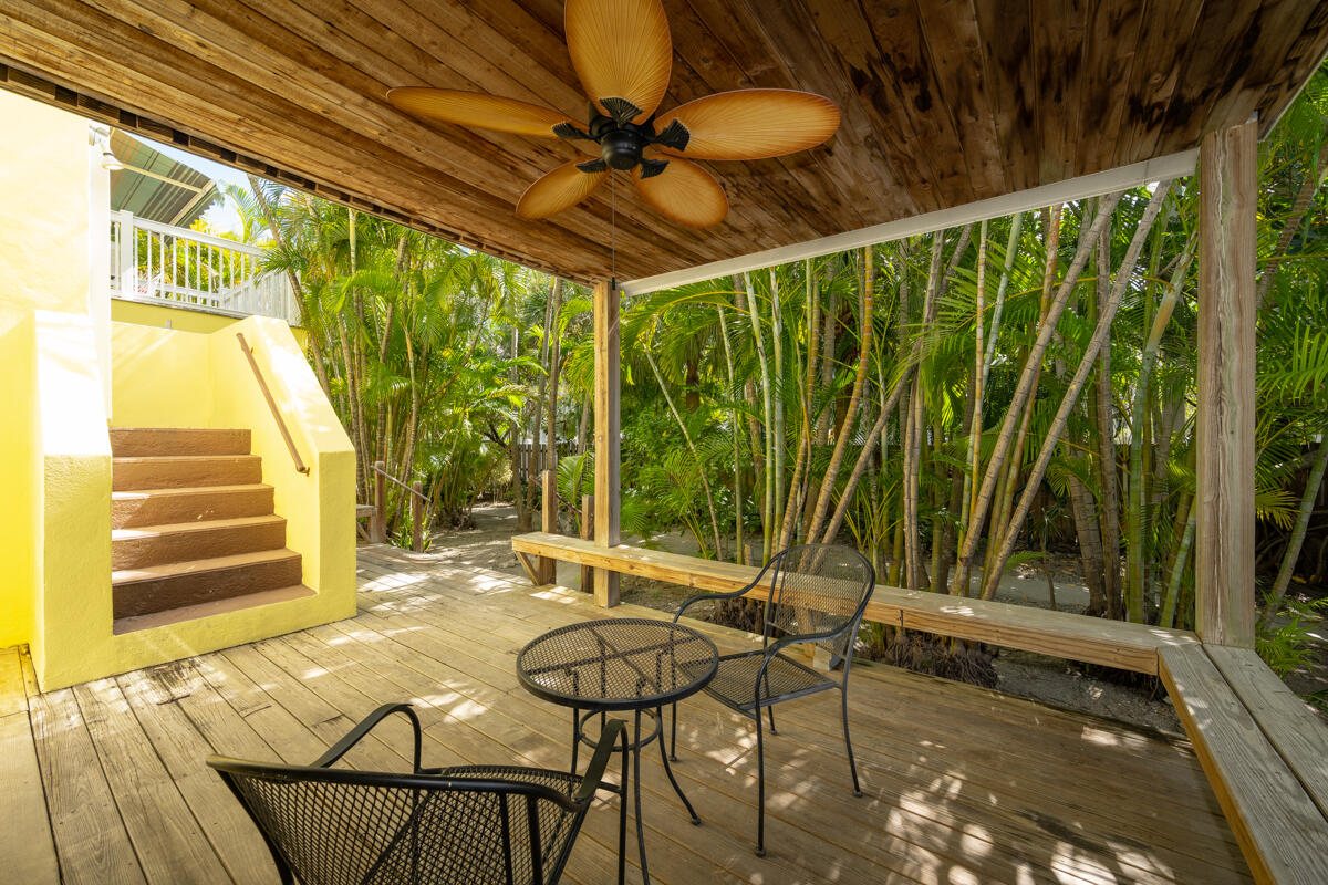 804 South Street, Unit 2 Key West, FL 33040 - Photo 13 of 17 a view of a patio with table and chairs with wooden floor and fence