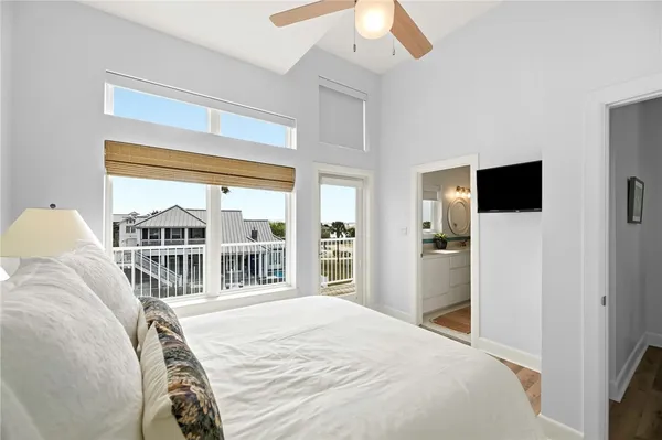 a bedroom with a bed and a large window with outer view