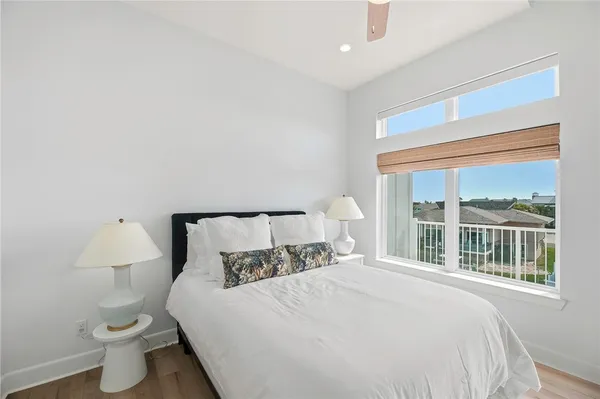 a large bed sitting in a bedroom next to a window