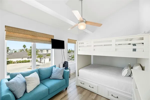 a bedroom with furniture and a large window