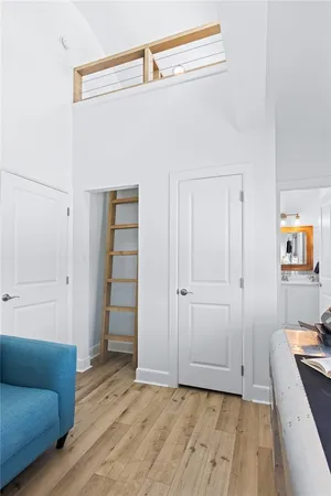 a view of a bedroom with wooden floor and closet