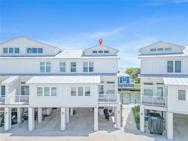 a front view of a building with a garden and entryway