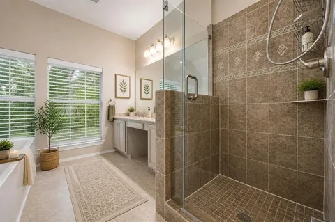 a bathroom with a sink a toilet a glass door shower and a mirror
