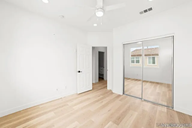 a bathroom with a sink a toilet a mirror and shower
