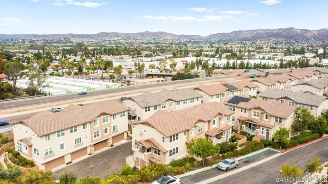 an aerial view of residential houses with a city view