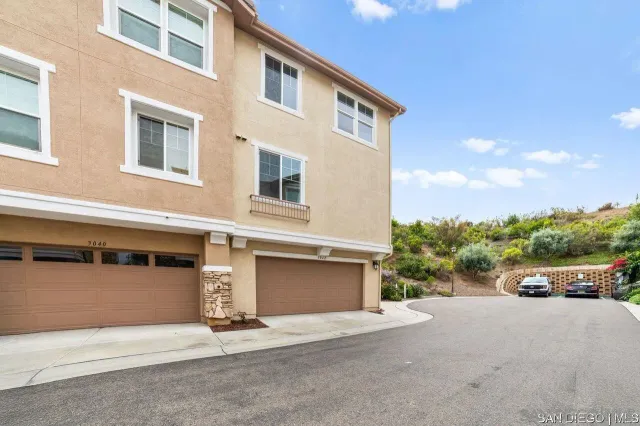 a front view of a house with a yard and a garage