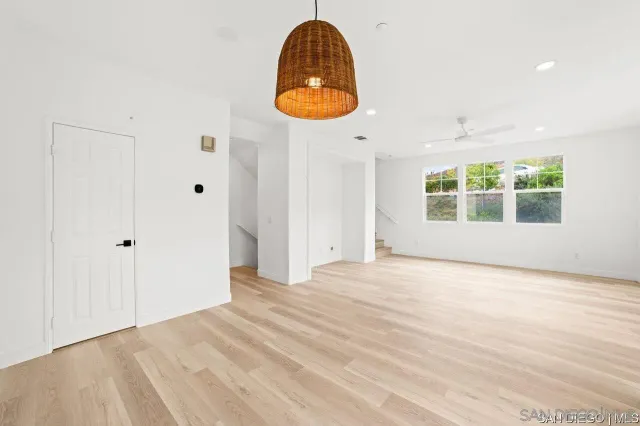 an empty room with window and wooden floor