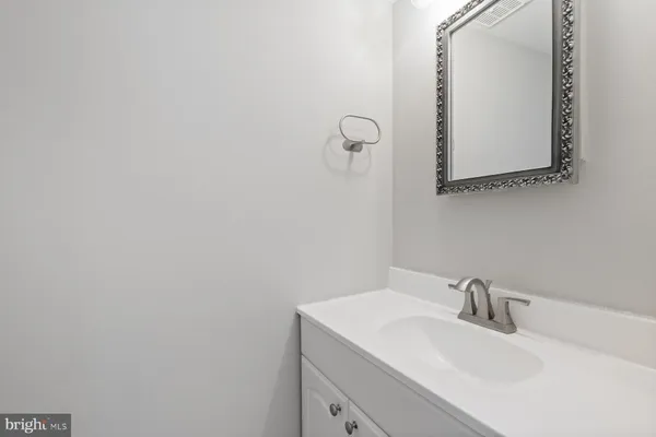 a bathroom with a sink and mirror