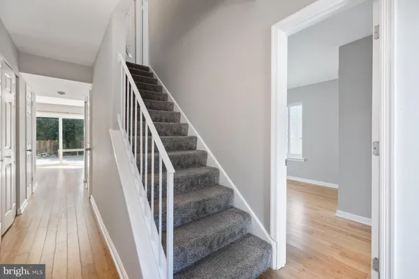 a view of a hallway with wooden floor and entryway