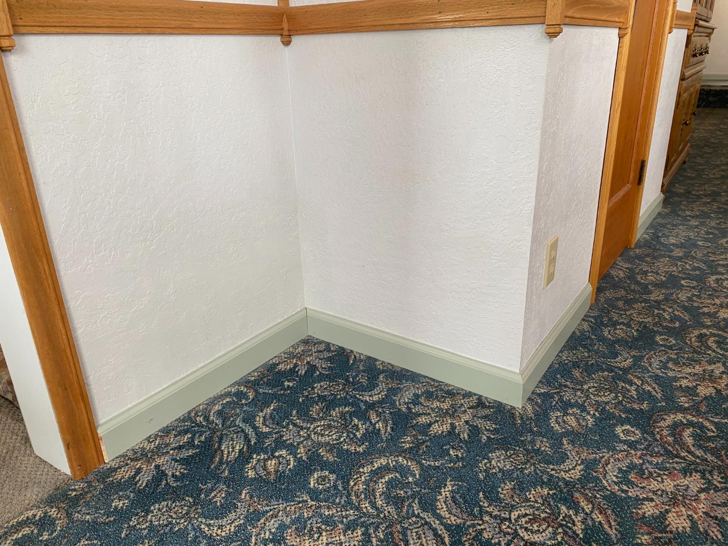 5021 Banbury Cross Road Shingle Springs, CA 95682 - Photo 23 of 92 A picture of the detailed wood trim across from the dining area. The wood burning stove vent closet can be seen next to it. Notice the baseboards.