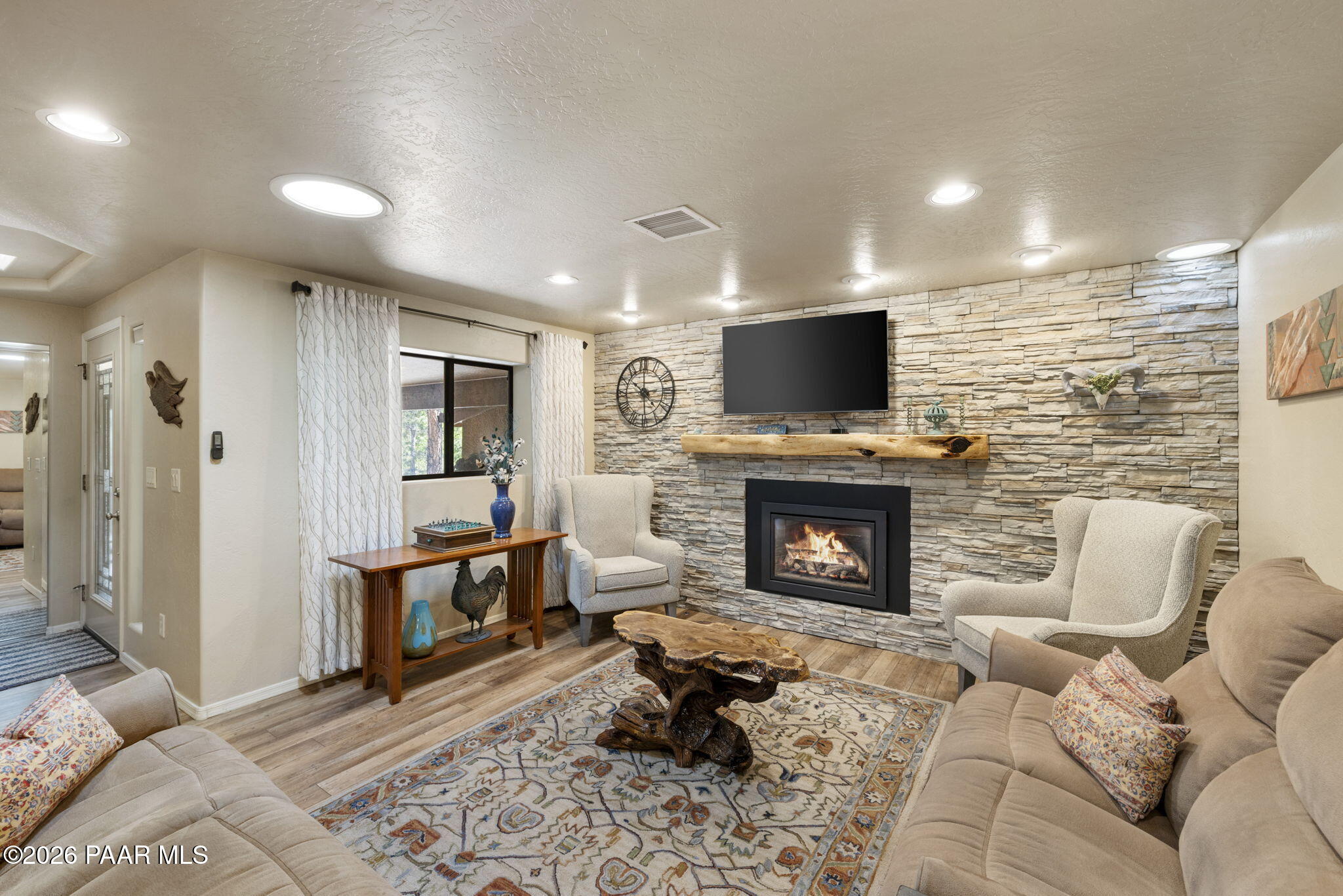535 Copper Basin Road Prescott, AZ 86303 - Photo 10 of 41 a living room with furniture a fireplace and a flat screen tv