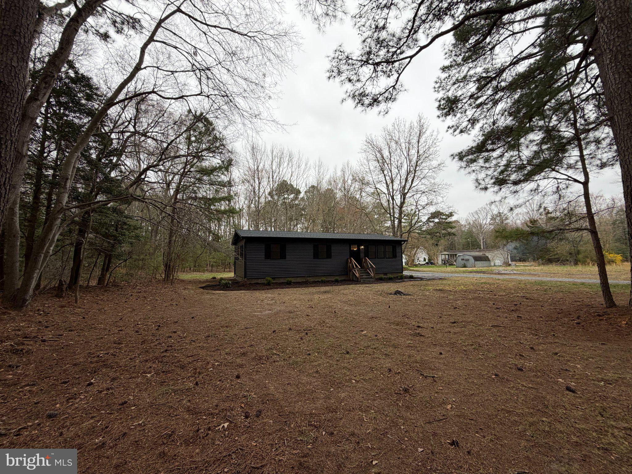 22206 Wetipquin Road Quantico, MD 21856 - Photo 3 of 19 Secluded black cottage in nature's embrace.