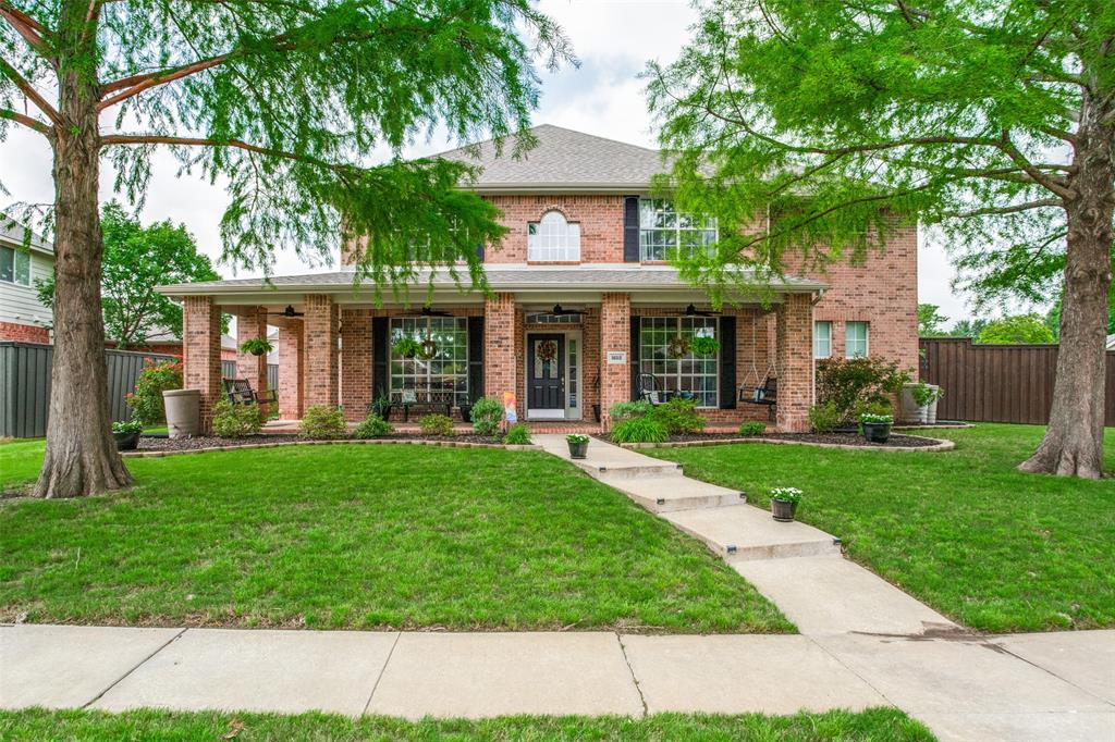 1612 Coventry Lane Allen, TX 75002 - Photo 1 of 39 Brick exterior home featuring a covered front porch with multiple columns, black window shutters, a central walkway, and mature trees framing the property