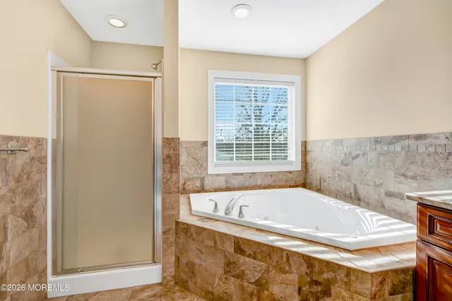 a bedroom with a bed and a ceiling fan