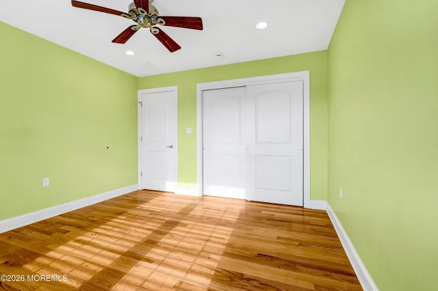 a view of a room with window and a ceiling fan