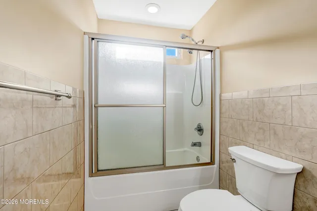 an empty room with furniture and a flat screen tv