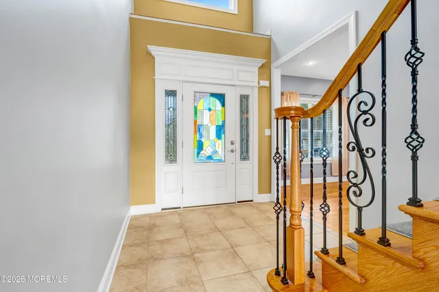a view of staircase with wooden floor and windows