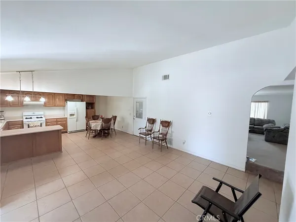 a view of hallway with a window and a kitchen