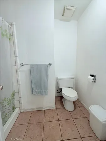 a view of a room with a ceiling fan and window