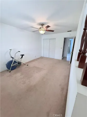 a bed room with a bed and a ceiling fan