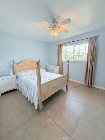 a bedroom with a bed and a lamp