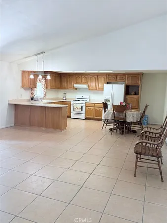a living room with kitchen island furniture and a kitchen view