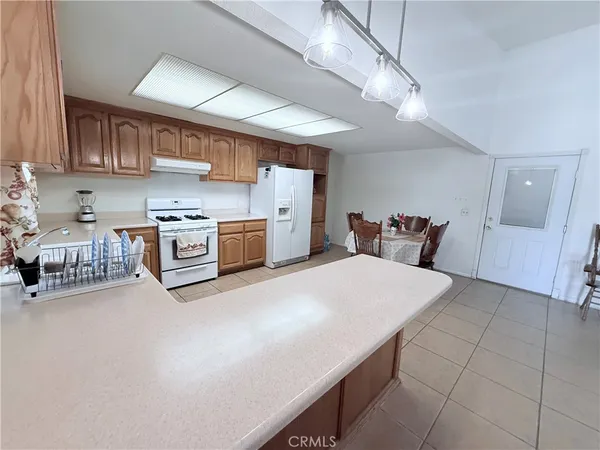 a living room with furniture and a dining table with chair