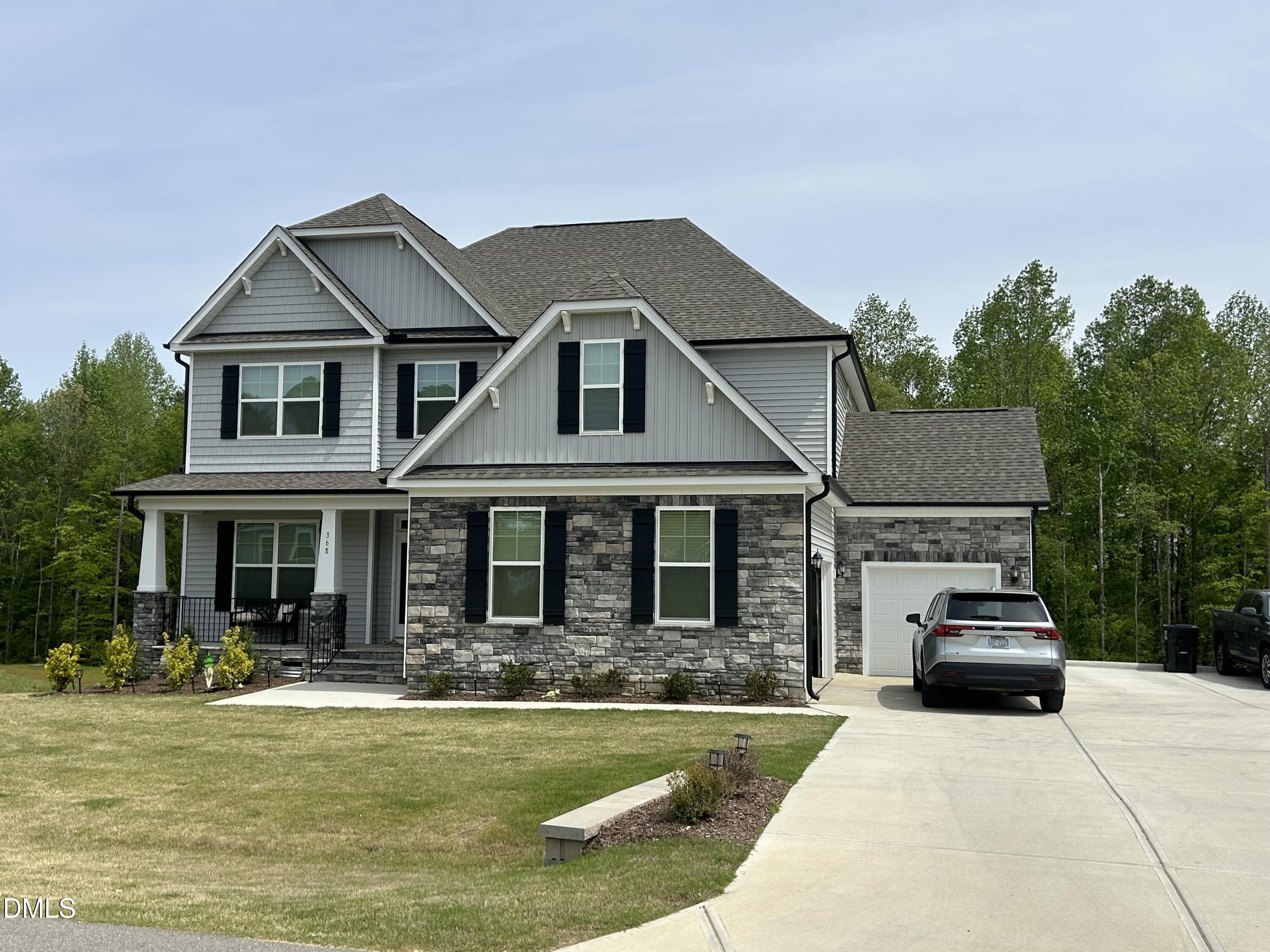 368 Rising Star Drive Clayton, NC 27520 - Photo 2 of 4 a front view of a house with swimming pool and porch