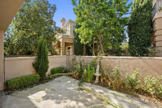 a view of a pathway of a house with a yard