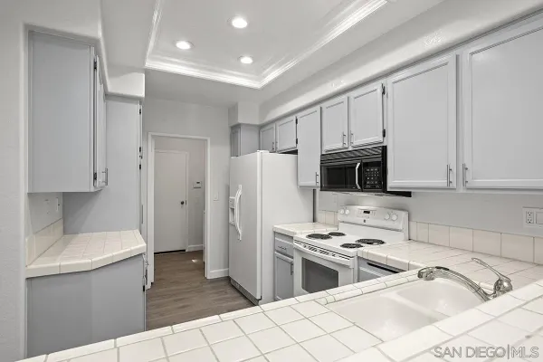 a kitchen with stainless steel appliances a refrigerator a sink a stove a microwave and cabinets