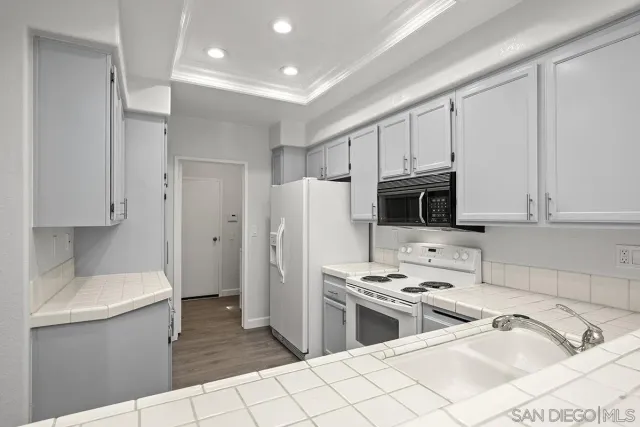 a kitchen with stainless steel appliances a refrigerator a sink a stove a microwave and cabinets