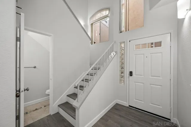 a view of an entryway with wooden floor