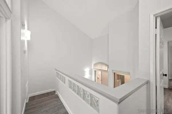 a view of hallway with wooden floor