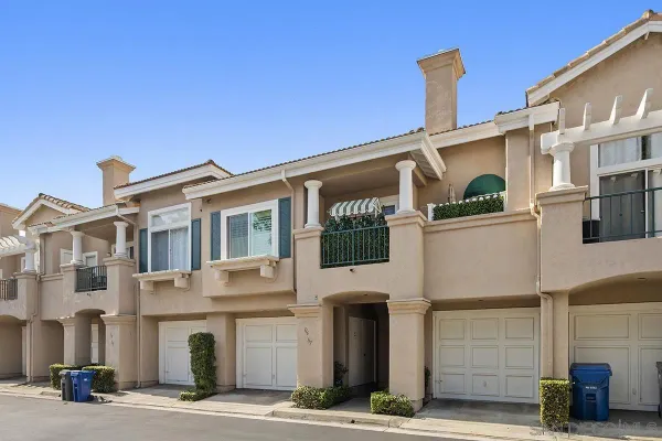 a front view of a building with parking area