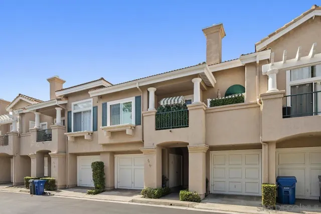a front view of a building with parking area