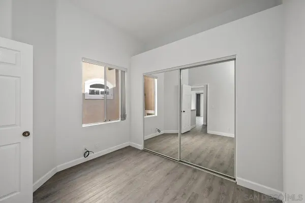 an empty room with windows and closet