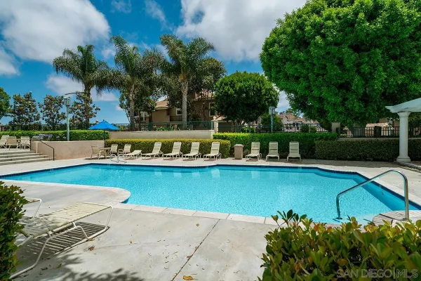 a view of swimming pool with outdoor seating and city view