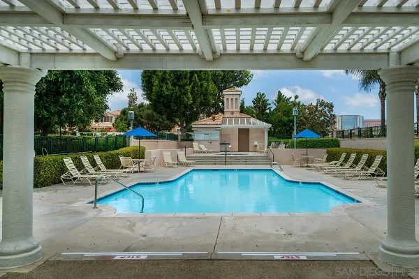 swimming pool view with a seating space