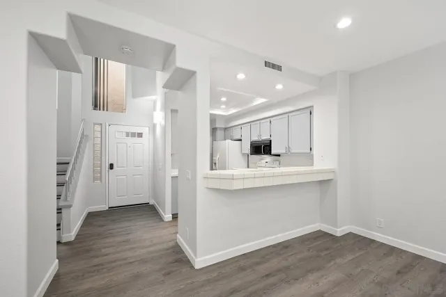a kitchen with stainless steel appliances a refrigerator and a sink