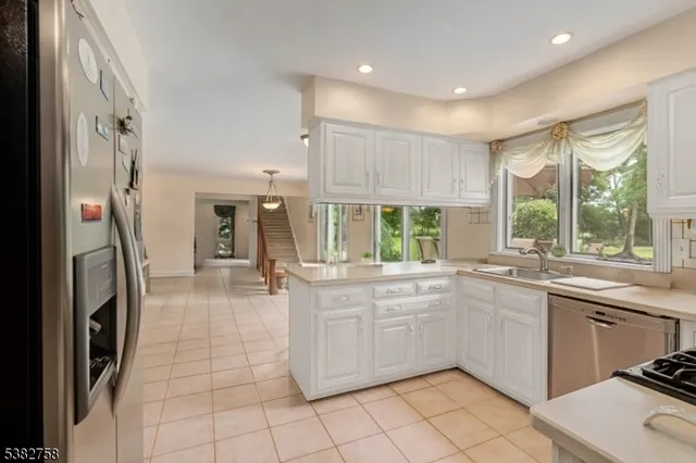 a kitchen with a sink stainless steel appliances and cabinets