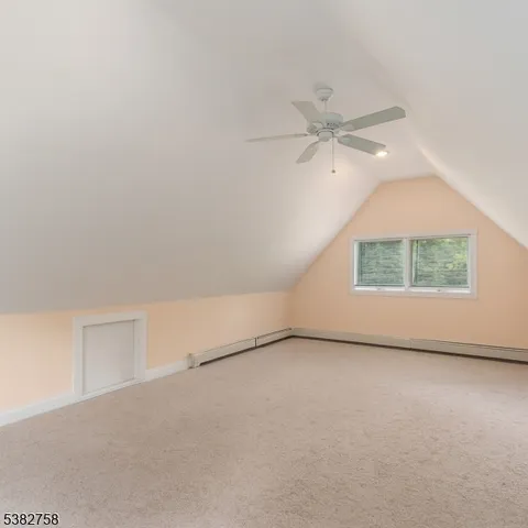 an empty room with a window and a ceiling fan