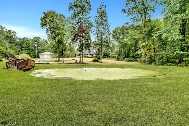 a swimming pool with trees in the background