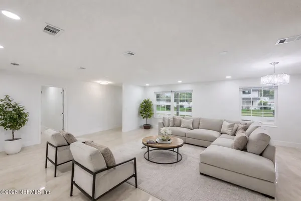 a living room with furniture and a large window