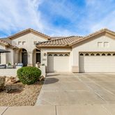 a view of a house with a yard and potted plants
