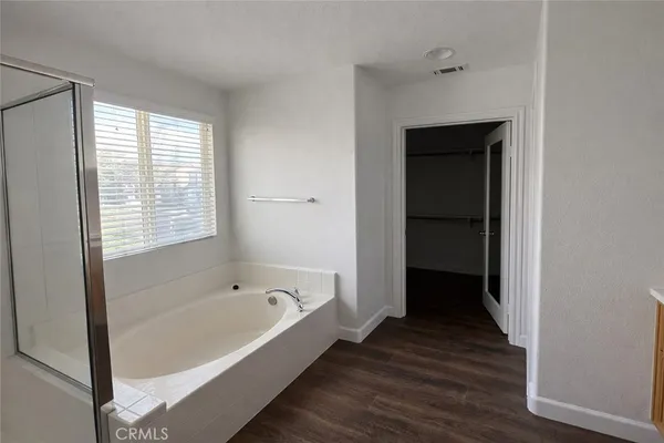 a bathroom with a bathtub and a window