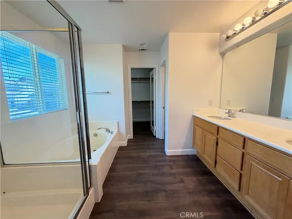 a bathroom with a double vanity sink and a mirror