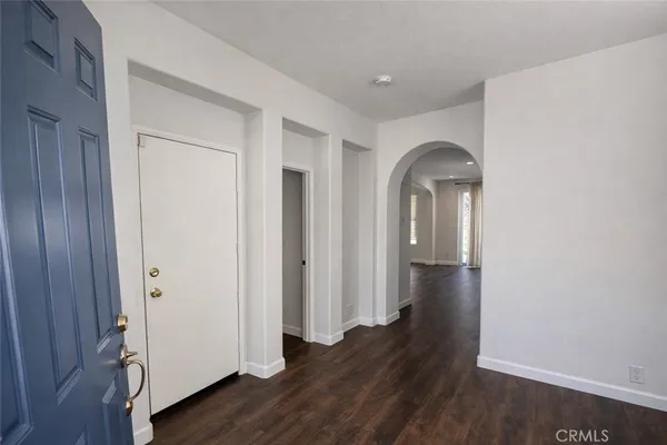 an empty room with wooden floor and closet